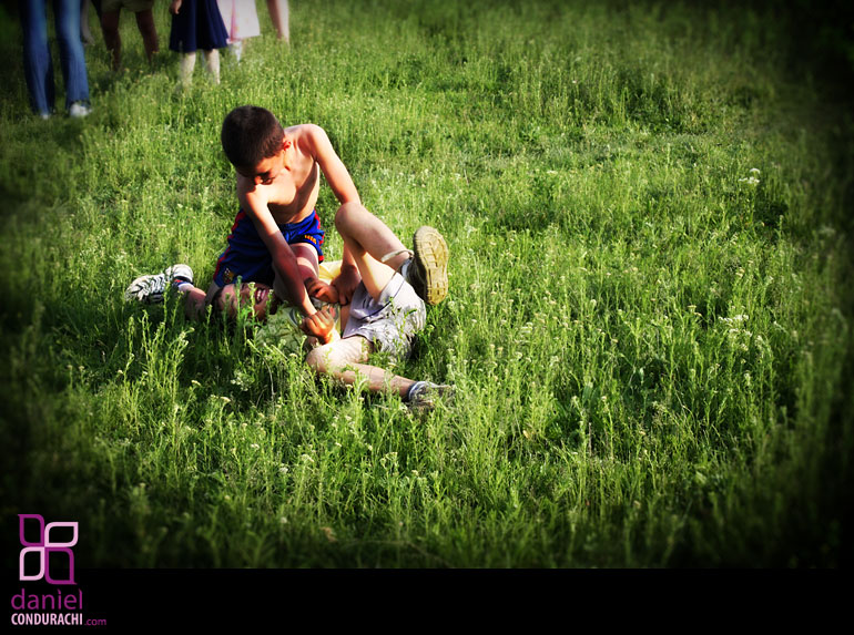Photo of boys playing in the grass while the girls watched at Comarna village Iasi district Romania